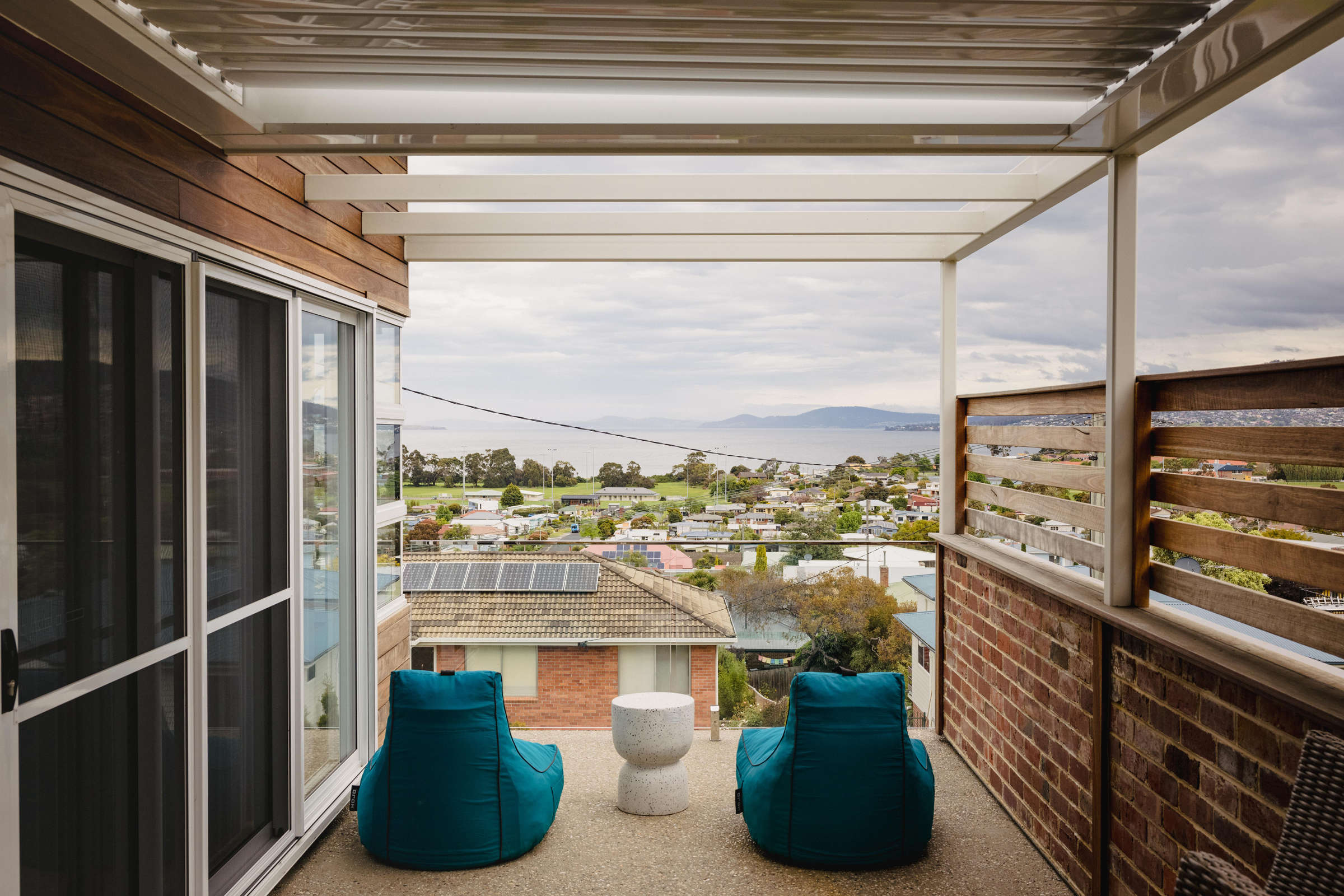 View of the River Derwent from the deck of this Howrah home renovation. The external deck features steel framework and a glass balustrade. Photo: Jordan Davis.
