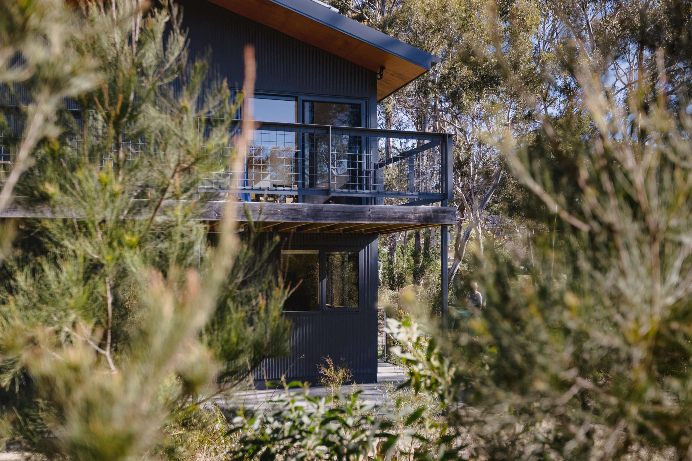 Mt Nelson home renovation, showcasing the built in area under the house, creating two additional bedrooms and a usable under-house storage space, and surrounded by bushland. Photo: Jordan Davis.